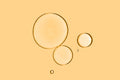 Three serum drops on a yellow background