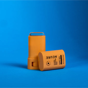 Sun screen stick SPF 50 packaging plastic stick with twist applicator on a blue background
